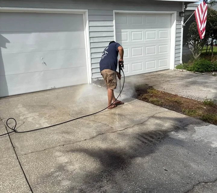 Bees pressure washing a residential driveway