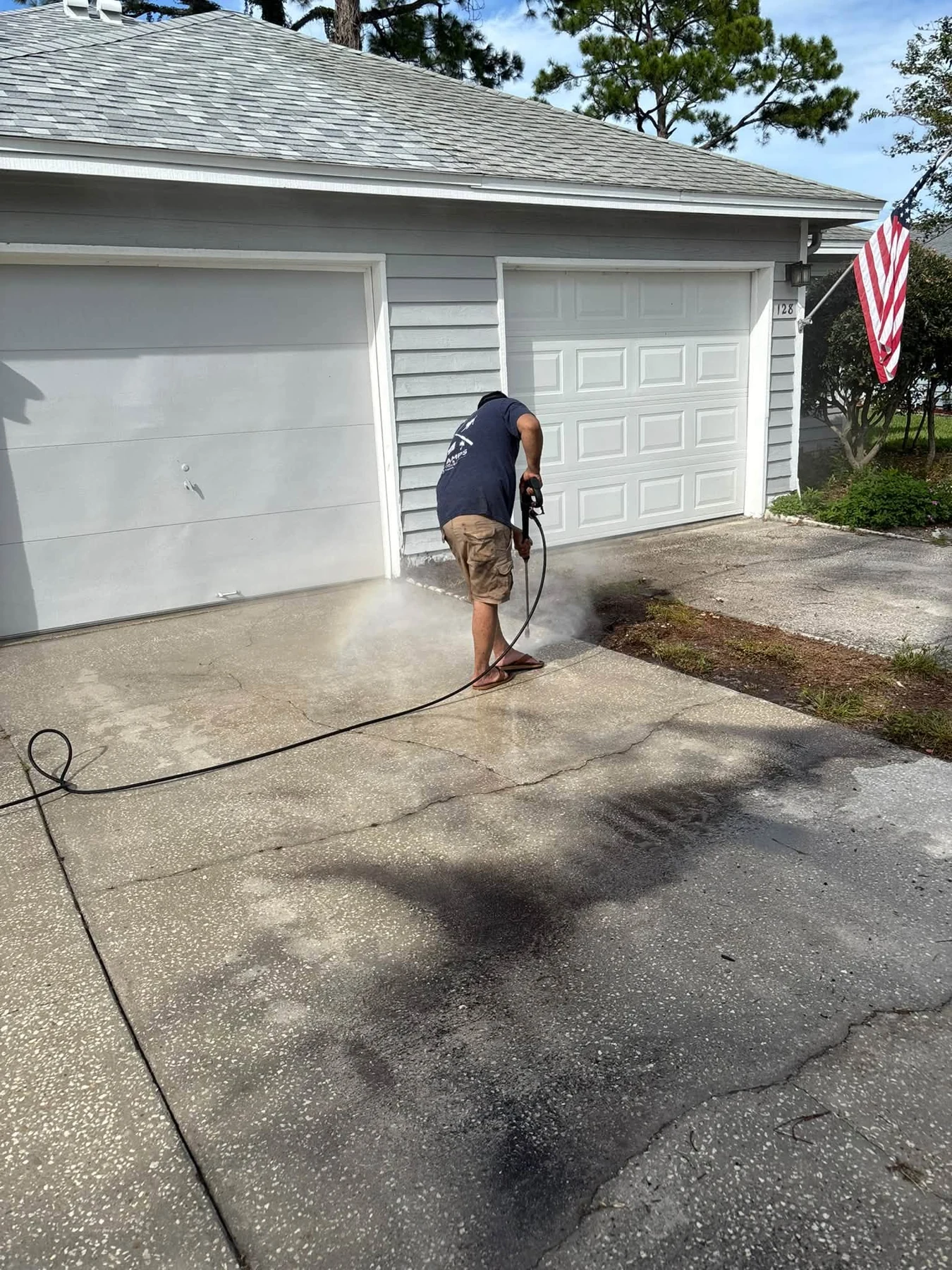 Bees pressure washing a residential driveway
